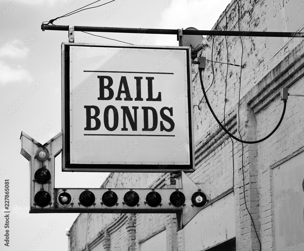 Aging Vintage Sign in Front of Samll Town Bail Bonds Office