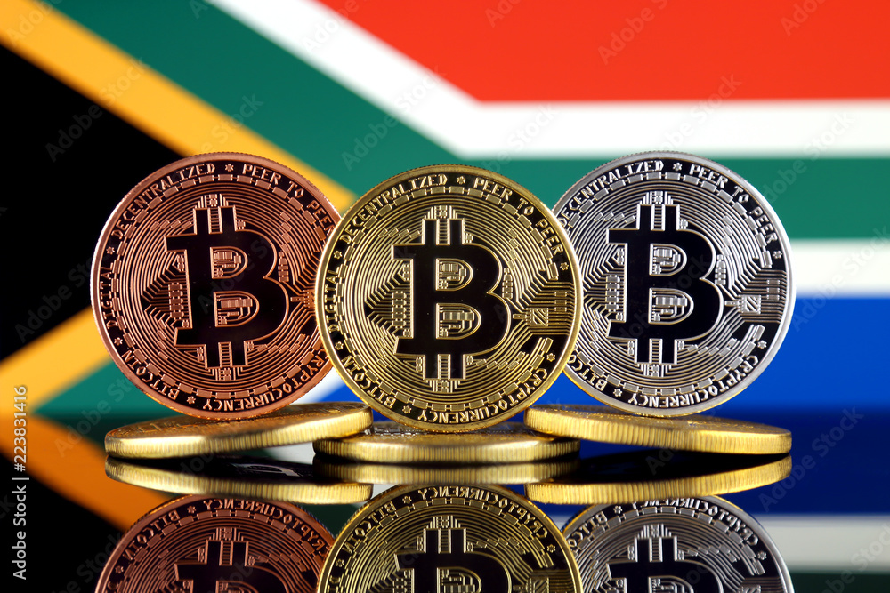 Physical version of Bitcoin (BTC) and South Africa Flag. Conceptual image for investors in High Technology (Cryptocurrency, Blockchain Technology, Smart Contracts, ICO).