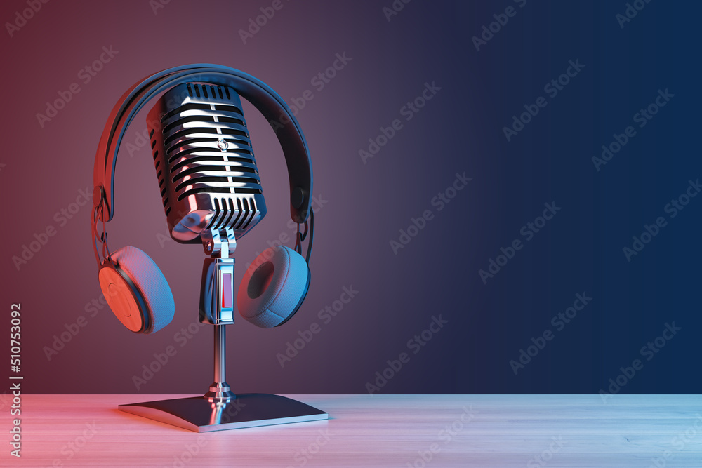 Podcasting and radio concept with retro microphone and headphones on empty wooden table and dark blank wall background with place for your logo or text. 3D rendering, mock up